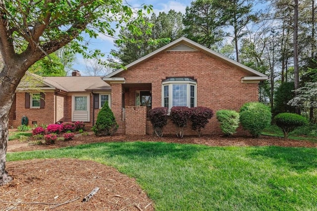 206 Swaim Ct, Salisbury, NC 28147 - view of front facade featuring brick siding, a front yard, and a chimney