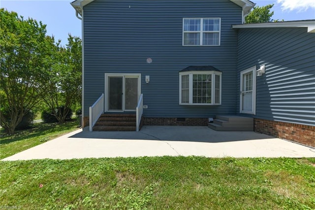 2377 Barber Rd, Elon, NC 27244 - rear view of house featuring entry steps, a yard, and a patio