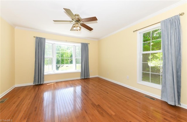 2377 Barber Rd, Elon, NC 27244 - empty room featuring healthy amount of natural light, wood-type flooring, baseboards, crown molding, and ceiling fan