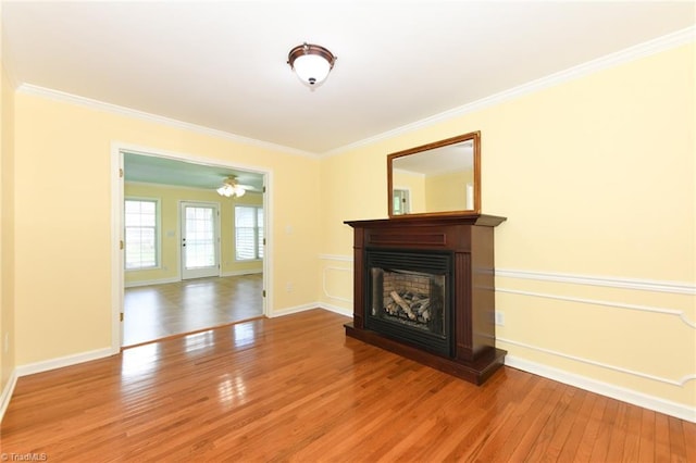 2377 Barber Rd, Elon, NC 27244 - unfurnished living room with hardwood / wood-style flooring, ornamental molding, a fireplace with raised hearth, and baseboards