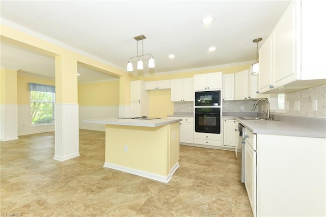 2377 Barber Rd, Elon, NC 27244 - kitchen with black appliances, a sink, white cabinetry, ornamental molding, and pendant lighting