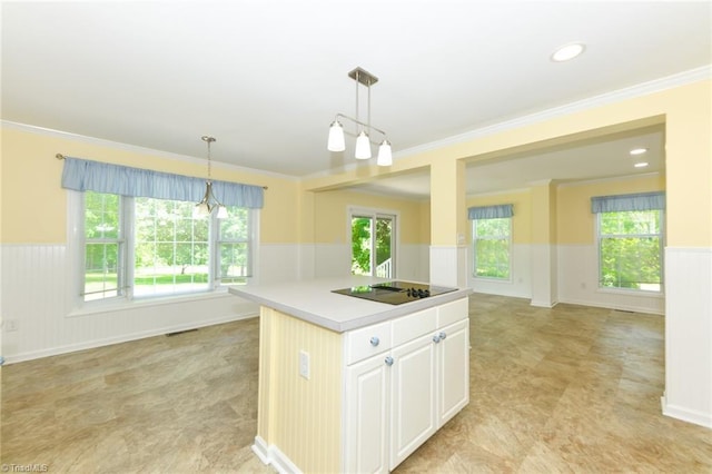 2377 Barber Rd, Elon, NC 27244 - kitchen featuring wainscoting, black electric cooktop, light countertops, pendant lighting, and plenty of natural light