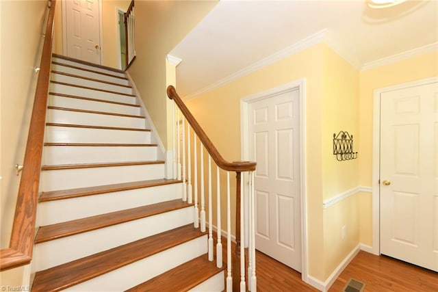 2377 Barber Rd, Elon, NC 27244 - staircase featuring wood finished floors, crown molding, and baseboards