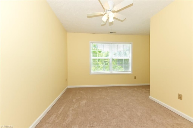 2377 Barber Rd, Elon, NC 27244 - spare room featuring light colored carpet, baseboards, and ceiling fan