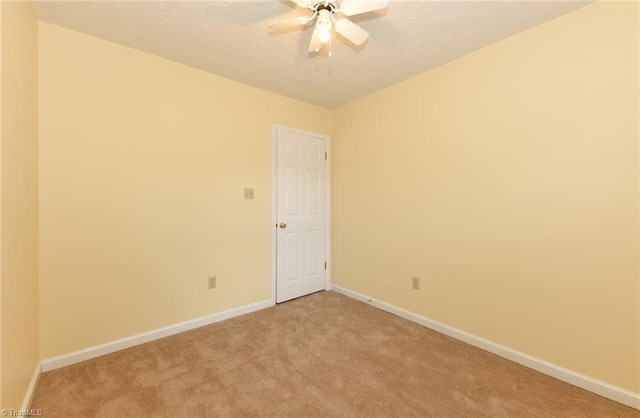 2377 Barber Rd, Elon, NC 27244 - unfurnished room with light colored carpet, baseboards, a textured ceiling, and ceiling fan