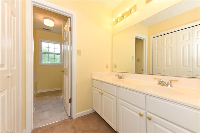 2377 Barber Rd, Elon, NC 27244 - bathroom with double vanity and baseboards