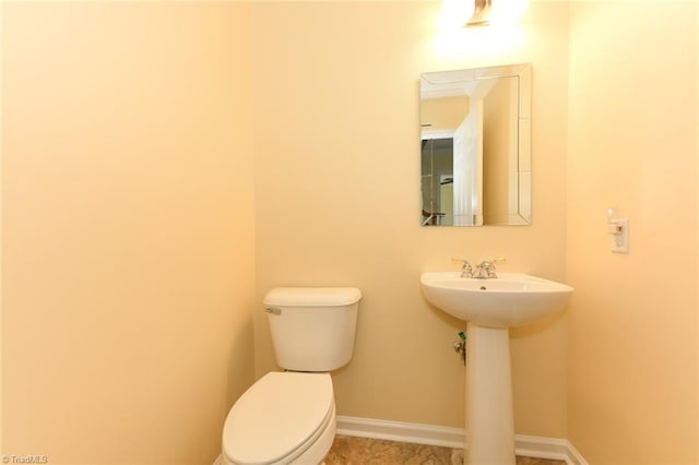 2377 Barber Rd, Elon, NC 27244 - bathroom with toilet, baseboards, and a sink