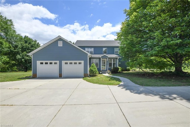 2377 Barber Rd, Elon, NC 27244 - view of front of house featuring driveway, a garage, and a front lawn