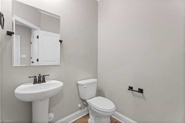 6975 Orchard Path Dr, Clemmons, NC 27012 - half bath featuring toilet, wood finished floors, and baseboards