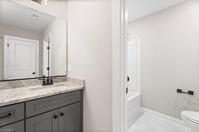 6975 Orchard Path Dr, Clemmons, NC 27012 - bathroom with baseboards, vanity, toilet, and marble look tiles