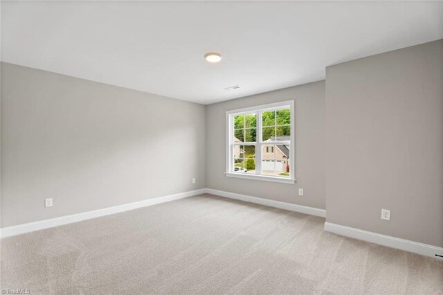 6975 Orchard Path Dr, Clemmons, NC 27012 - empty room with baseboards and light colored carpet