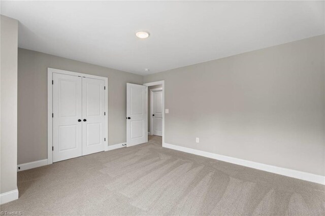 6975 Orchard Path Dr, Clemmons, NC 27012 - unfurnished bedroom with carpet flooring, baseboards, and a closet