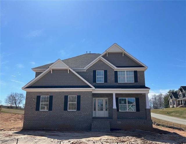 craftsman-style home with covered porch and brick siding