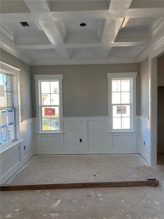 unfurnished room featuring a wainscoted wall, coffered ceiling, and ornamental molding