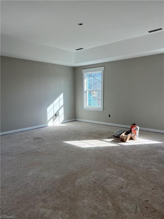 spare room with visible vents and baseboards