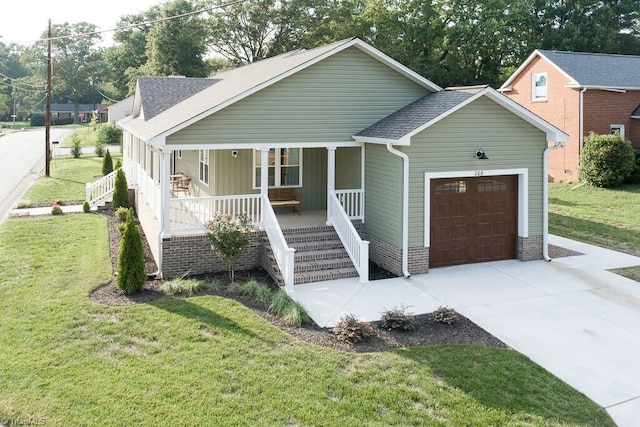 view of front of property with a garage, a front lawn, and a porch