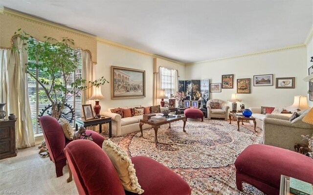 living room featuring light carpet, ornamental molding, and a healthy amount of sunlight