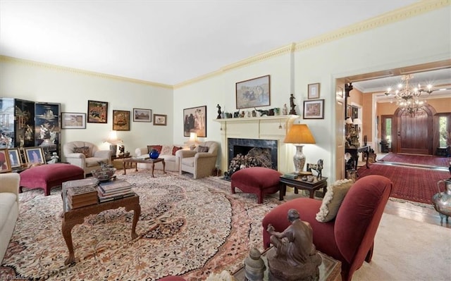 carpeted living room featuring an inviting chandelier, crown molding, and a high end fireplace