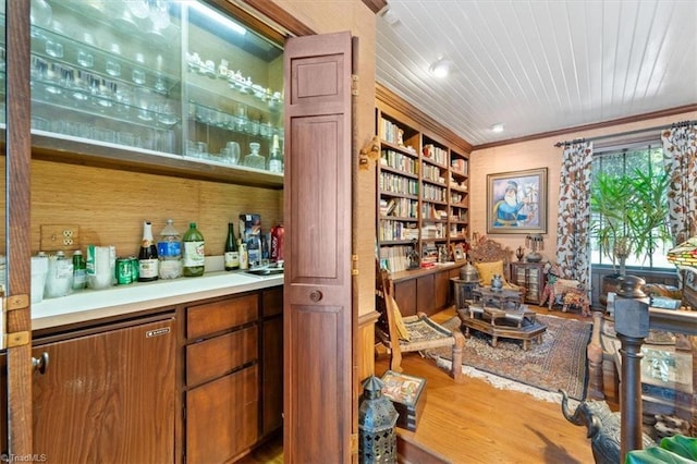 bar featuring wood ceiling, ornamental molding, built in shelves, and hardwood / wood-style floors