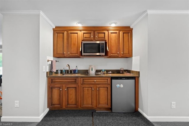 kitchen with dark colored carpet, crown molding, sink, and refrigerator