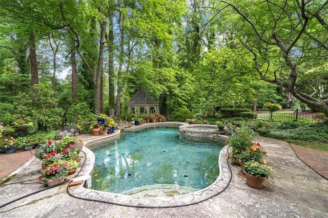 view of swimming pool featuring a gazebo, a patio, and an in ground hot tub