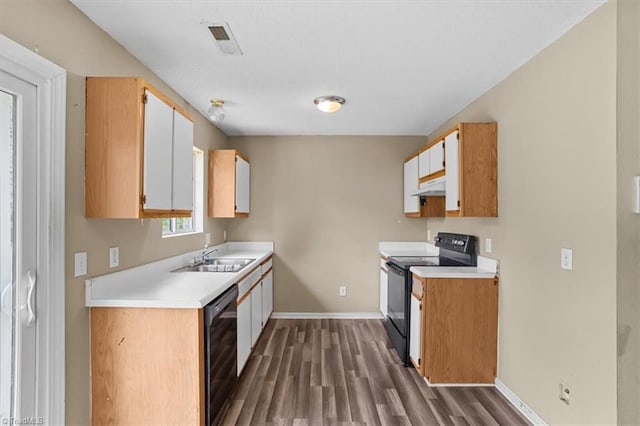 4103 Scotney Dr, Greensboro, NC 27407 - kitchen with black appliances, under cabinet range hood, dark wood-type flooring, and light countertops
