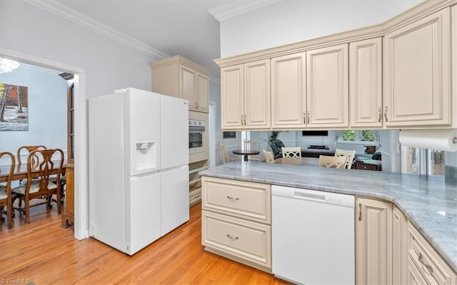 kitchen featuring light stone counters, cream cabinets, white appliances, crown molding, and light wood finished floors