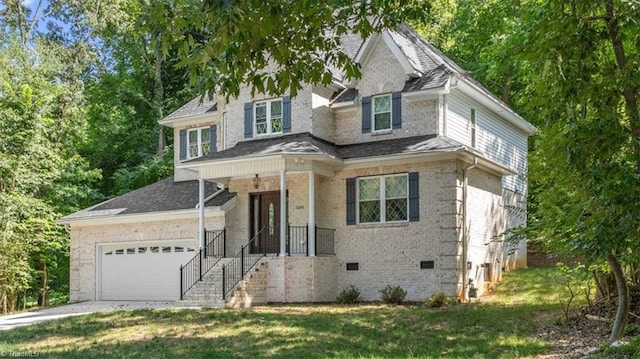 view of front of house with crawl space, a front lawn, an attached garage, and driveway