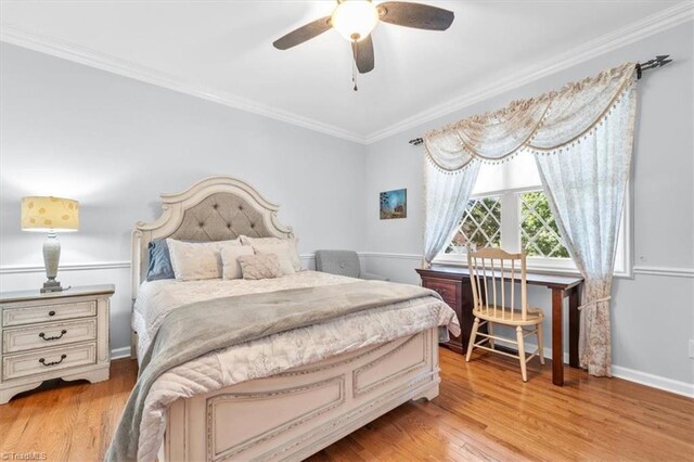 bedroom featuring light wood-type flooring, baseboards, a ceiling fan, and crown molding