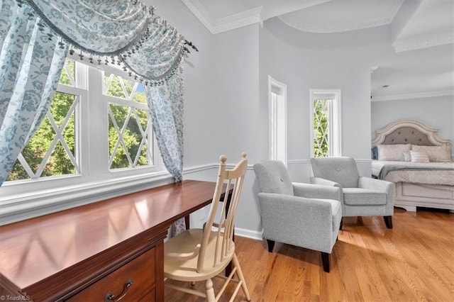 bedroom featuring multiple windows, ornamental molding, and light wood finished floors