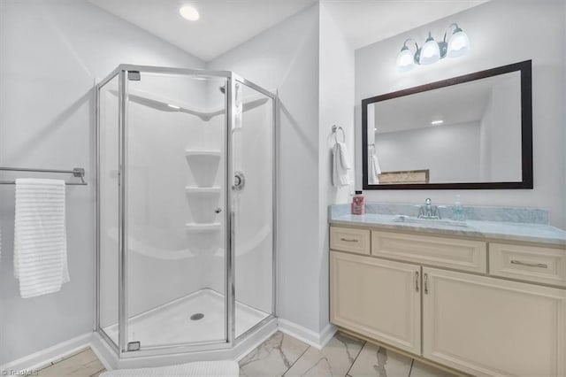 bathroom with marble finish floor, a stall shower, recessed lighting, baseboards, and vanity