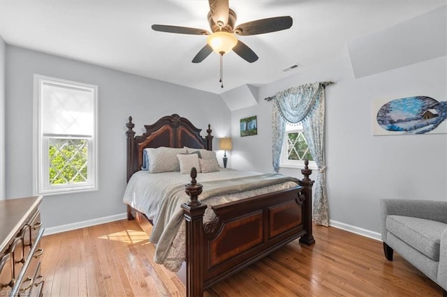 bedroom with a ceiling fan, baseboards, visible vents, and light wood-type flooring