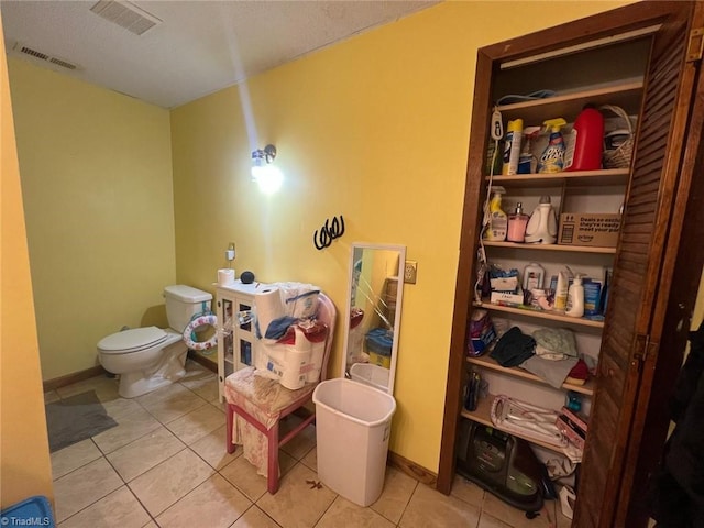 bathroom featuring tile patterned floors and toilet