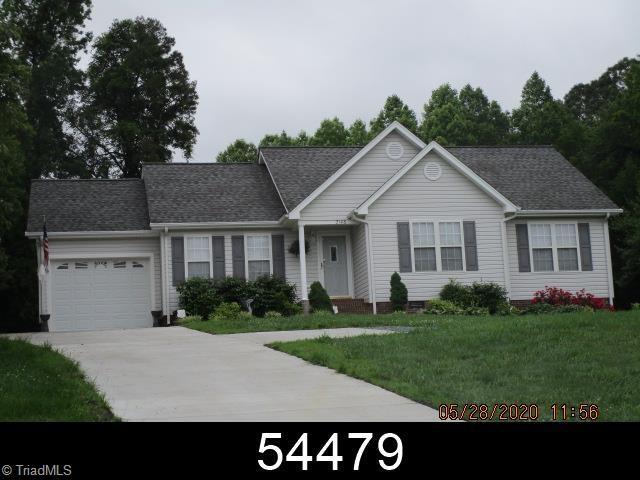 2146 Regency Dr, Randleman, NC 27317 - ranch-style house with concrete driveway, an attached garage, a front yard, and a shingled roof
