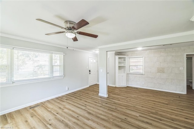 interior space with light wood-type flooring, crown molding, and ceiling fan