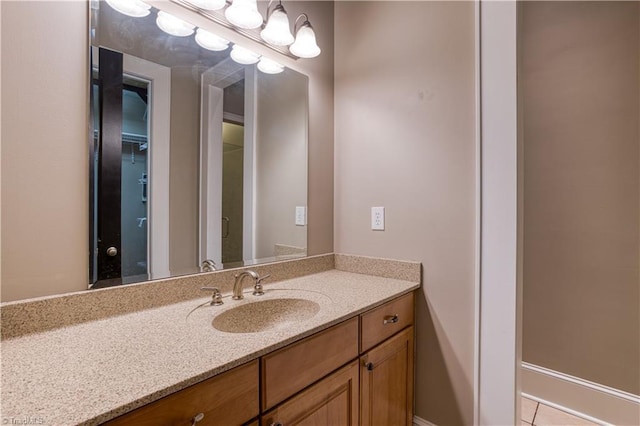 bathroom with a chandelier and vanity