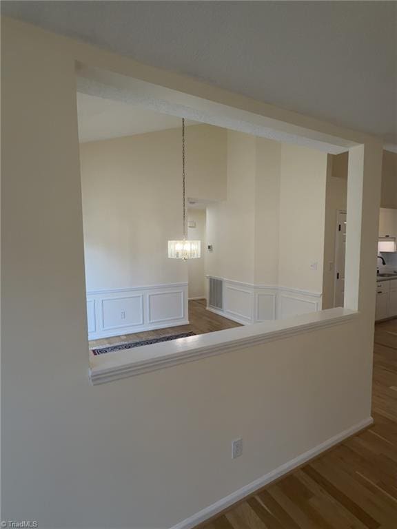 interior space featuring hardwood / wood-style floors and a notable chandelier