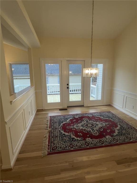 dining area featuring hardwood / wood-style flooring and a chandelier