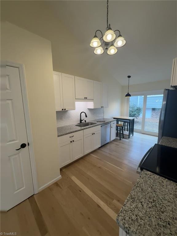 kitchen with sink, decorative light fixtures, white cabinets, and appliances with stainless steel finishes