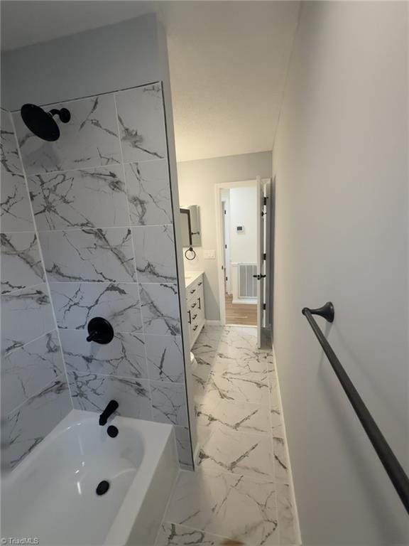 bathroom with vanity and tiled shower / bath combo