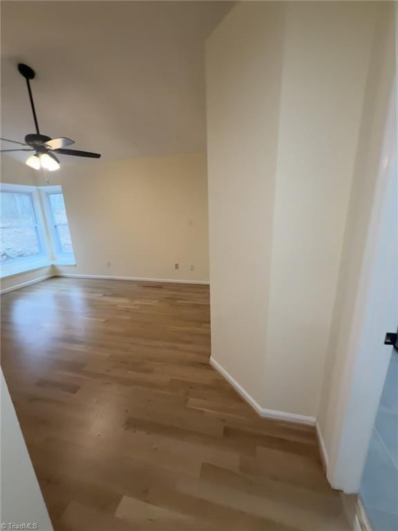 spare room with hardwood / wood-style floors and ceiling fan