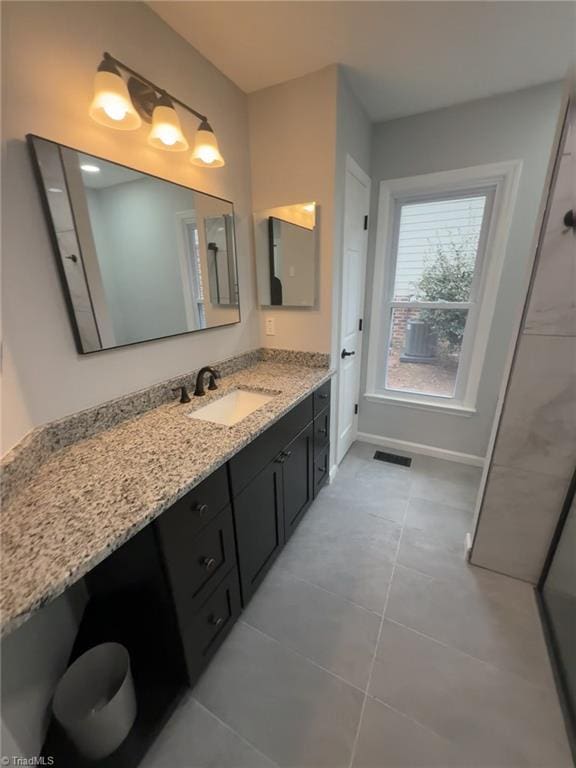 bathroom featuring tile patterned flooring and vanity