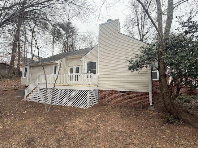 back of house featuring central AC and a deck