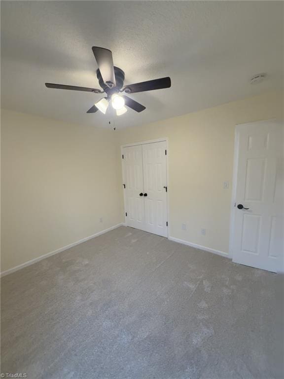 unfurnished bedroom with a closet, ceiling fan, and carpet flooring