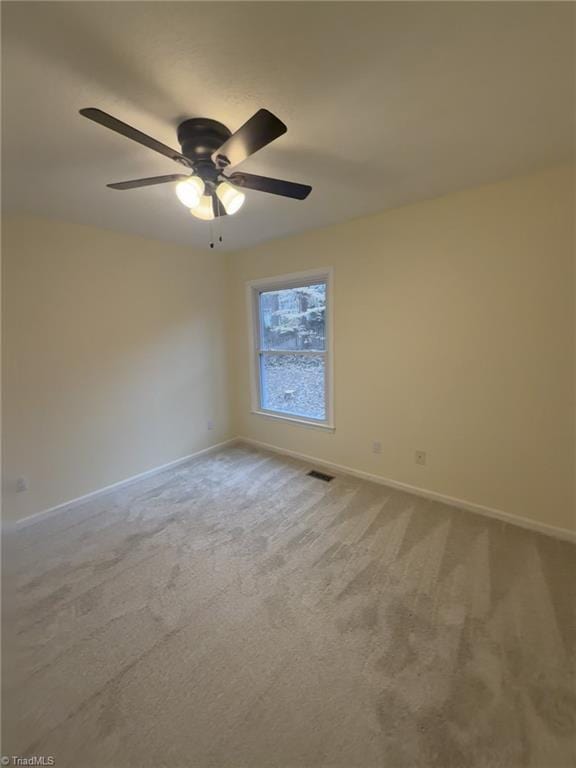 empty room featuring ceiling fan and carpet flooring