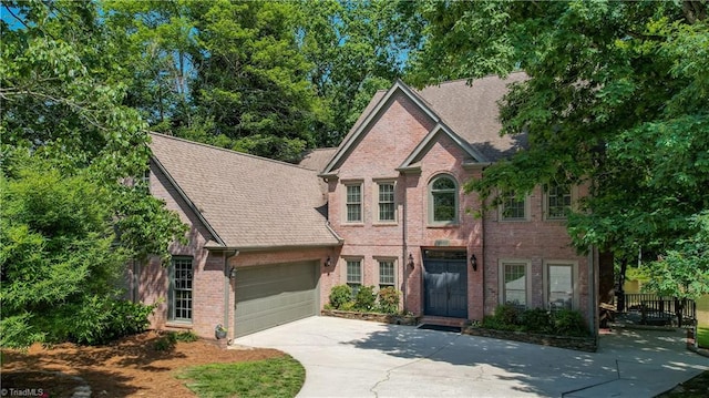 5300 Coveview Ct, Greensboro, NC 27407 - view of front of house featuring driveway, a garage, brick siding, and roof with shingles