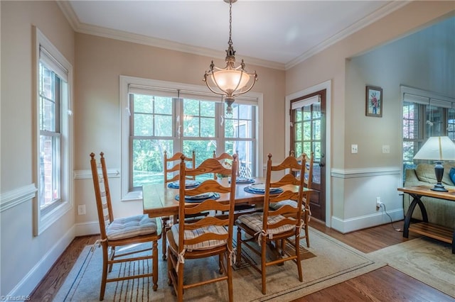 dining area featuring baseboards, wood finished floors, and a healthy amount of sunlight