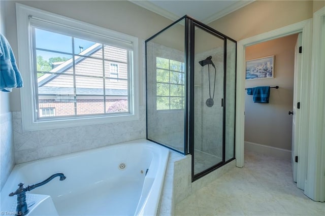bathroom with a whirlpool tub, a healthy amount of sunlight, and a shower stall