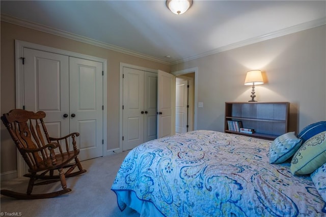 carpeted bedroom featuring two closets and crown molding