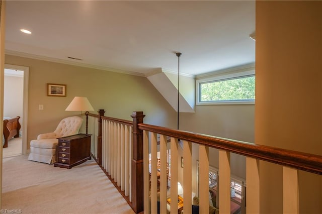 hallway with crown molding, visible vents, an upstairs landing, and light colored carpet